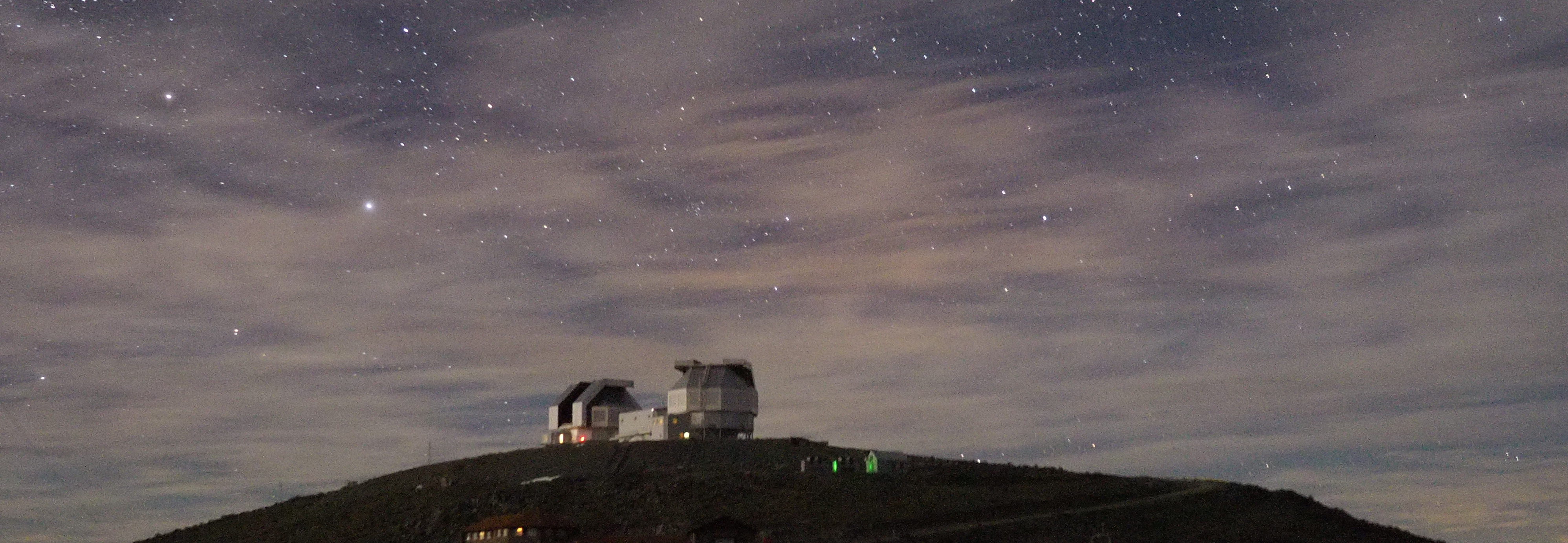 Stars and clouds over the Magellan Telescopes, Las Campanas Observatory. Photo by Ewan Douglas, Aug 2017.
